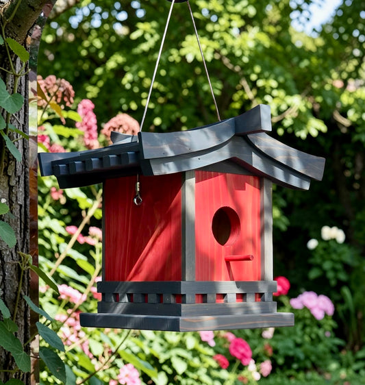 Birdhouse shaped like a traditional Japanese lantern hanging in a garden.